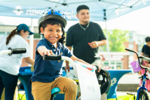 Boy with blue polo on bike